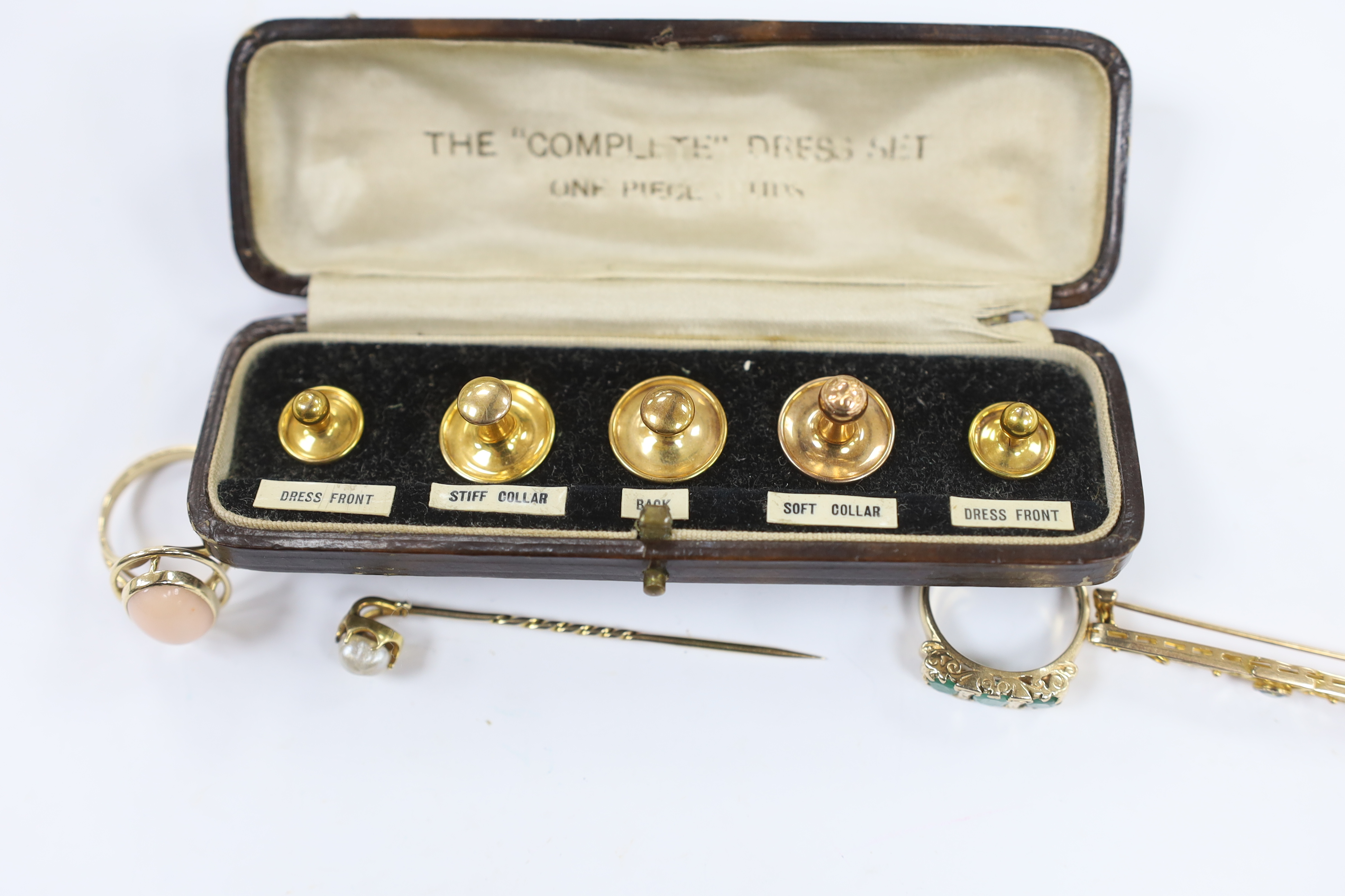Sundry jewellery including a 14ct gold and cabochon coral set ring, a 9ct gold and gem set ring, a yellow metal and gem set bar brooch, a yellow metal and baroque pearl set stick pin and a cased five piece dress stud set